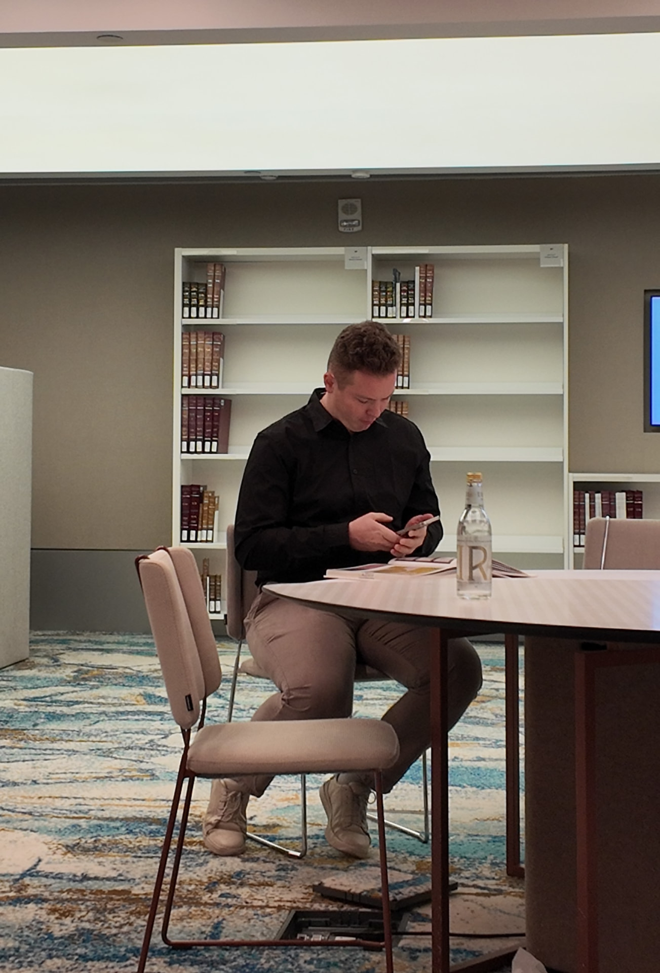 Nikita reviewing project material in an architectural library